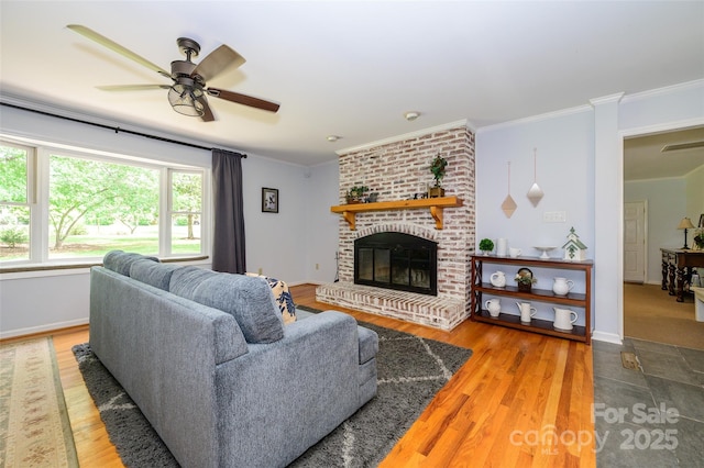 13030 Mayes Rd, Huntersville, NC 28078 - living room with wood finished floors, crown molding, a brick fireplace, a ceiling fan, and baseboards