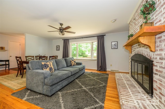 13030 Mayes Rd, Huntersville, NC 28078 - living room with light wood-type flooring, a fireplace, visible vents, and a ceiling fan