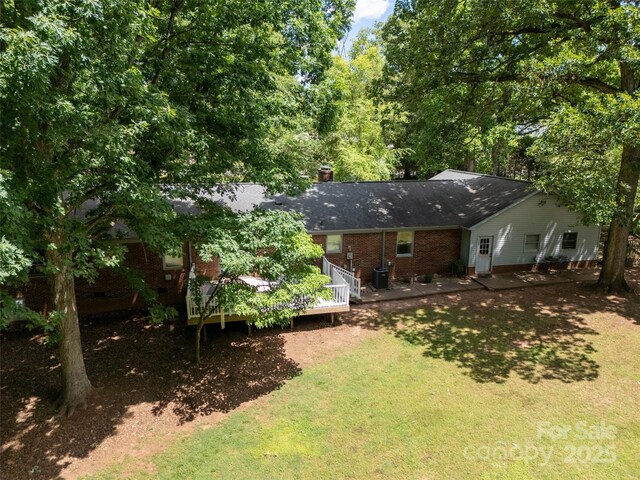 13030 Mayes Rd, Huntersville, NC 28078 - back of house with brick siding, a yard, a deck, crawl space, and a chimney