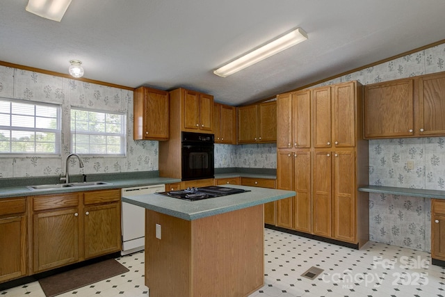 kitchen with a kitchen island, light floors, wallpapered walls, a sink, and black appliances