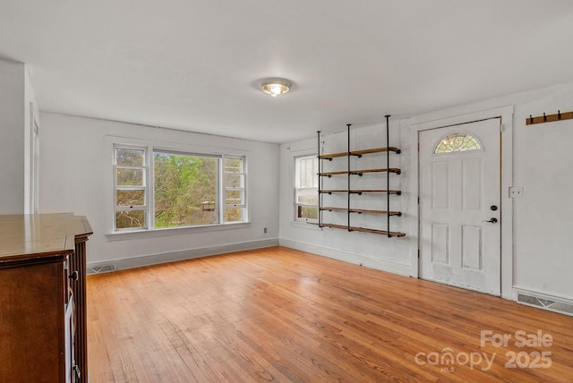 entrance foyer with light wood-type flooring and baseboards