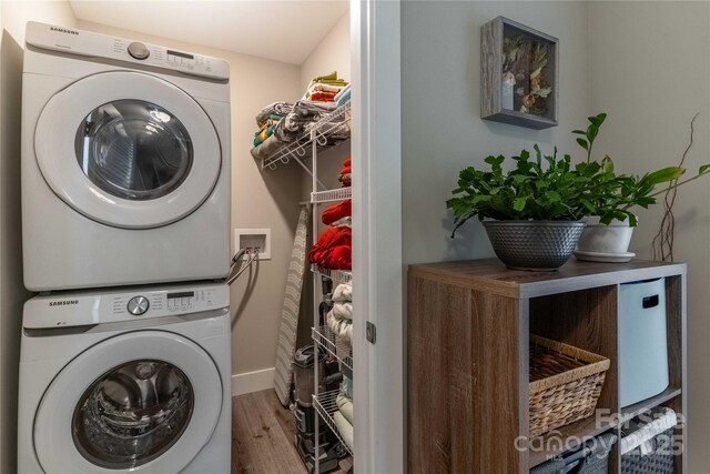 60 Wheeler Rd, Weaverville, NC 28787 - clothes washing area with stacked washing machine and dryer, wood finished floors, and baseboards