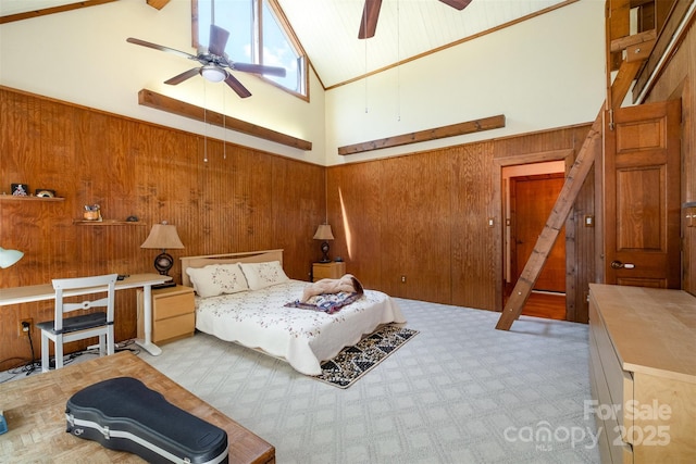 bedroom featuring wood walls and high vaulted ceiling