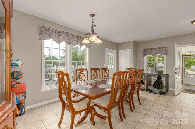 804 Rostan St SE, Valdese, NC 28690 - dining area with light tile patterned floors, baseboards, and a chandelier