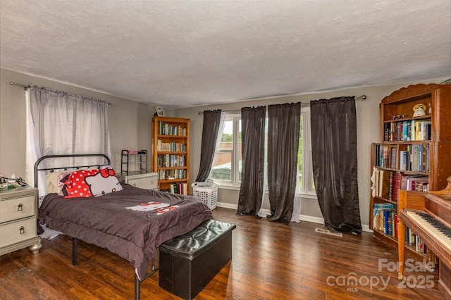 804 Rostan St SE, Valdese, NC 28690 - bedroom with a textured ceiling, wood finished floors, and baseboards
