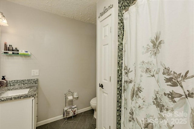 804 Rostan St SE, Valdese, NC 28690 - bathroom featuring toilet, vanity, baseboards, a textured ceiling, and tile patterned flooring