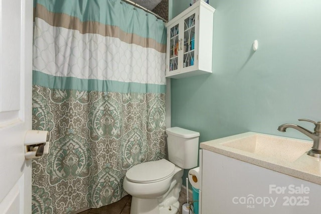 804 Rostan St SE, Valdese, NC 28690 - full bath featuring toilet, a shower with shower curtain, vanity, and tile patterned flooring