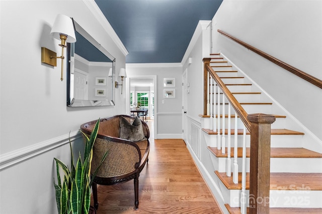 interior space with ornamental molding and wood finished floors