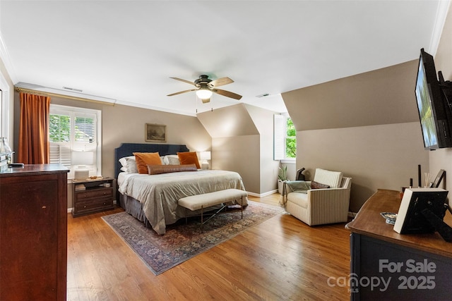 bedroom with visible vents, a ceiling fan, light wood finished floors, and lofted ceiling