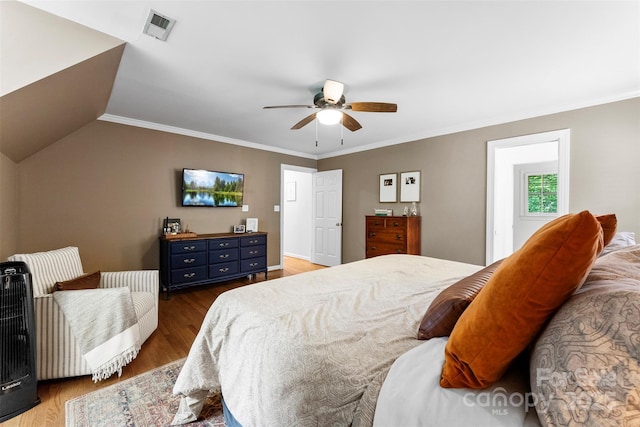 bedroom featuring visible vents, ornamental molding, ceiling fan, and wood finished floors