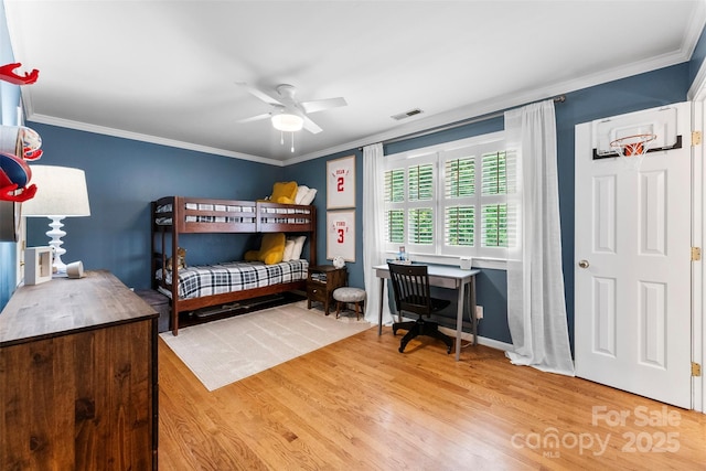 bedroom with a ceiling fan, visible vents, ornamental molding, and wood finished floors