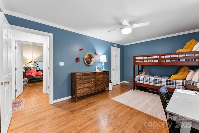 bedroom with ornamental molding and light wood finished floors