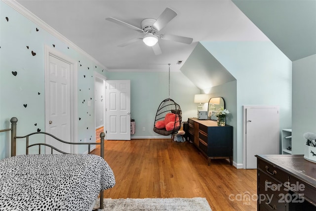 bedroom with crown molding, ceiling fan, light wood-style flooring, baseboards, and visible vents