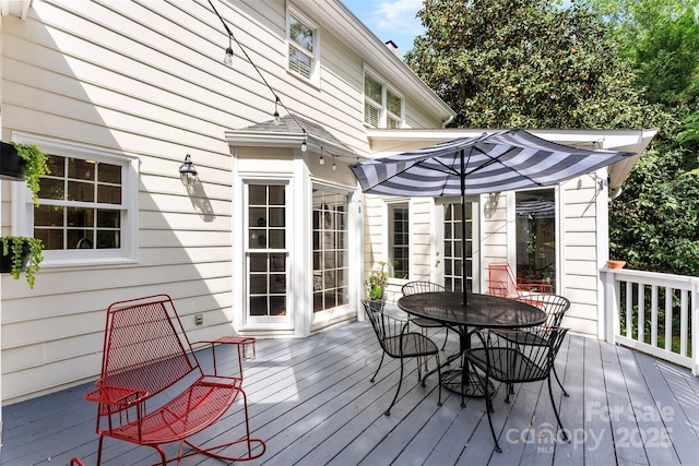 wooden deck featuring outdoor dining area