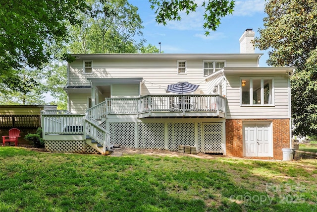 rear view of property with a chimney, a wooden deck, stairway, brick siding, and a yard