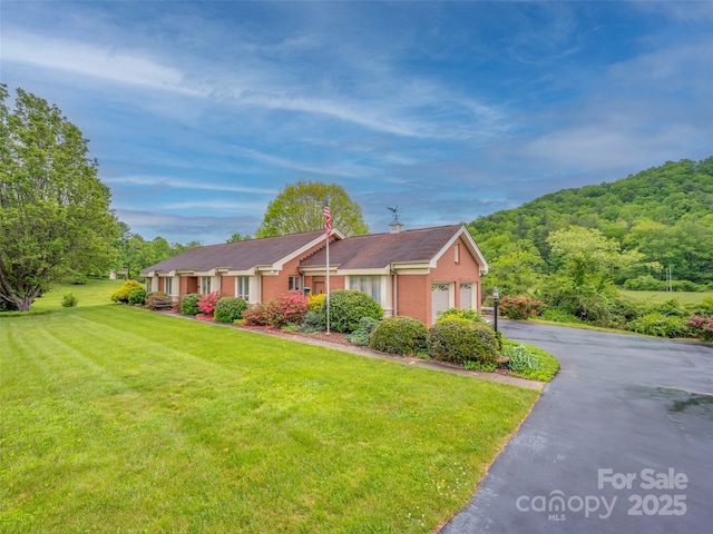 view of front of house with a garage and a front yard
