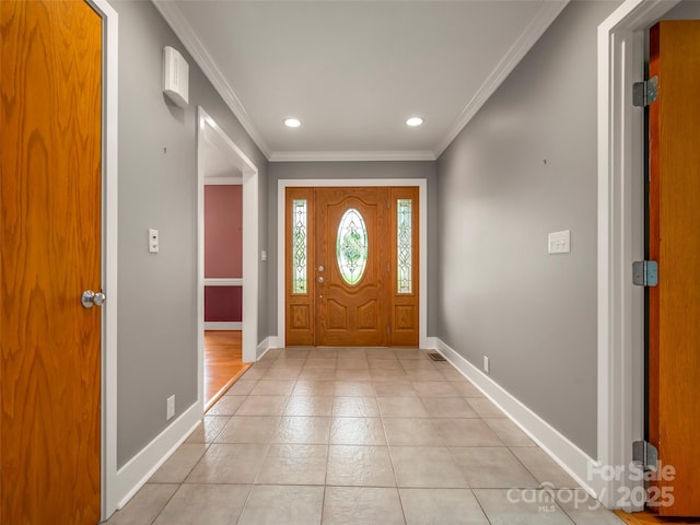foyer entrance featuring ornamental molding, baseboards, recessed lighting, and light tile patterned floors