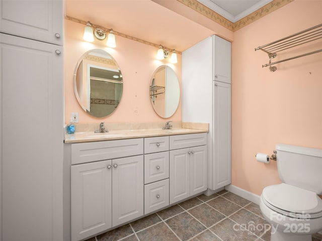 full bathroom with toilet, double vanity, tile patterned flooring, baseboards, and crown molding