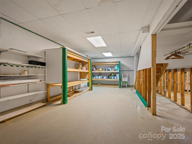 basement featuring a drop ceiling