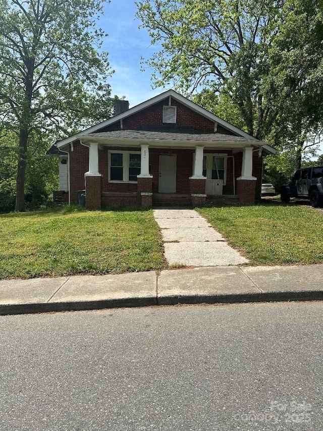 621 Benton St, Monroe, NC 28110 - view of front of home with brick siding and a front yard