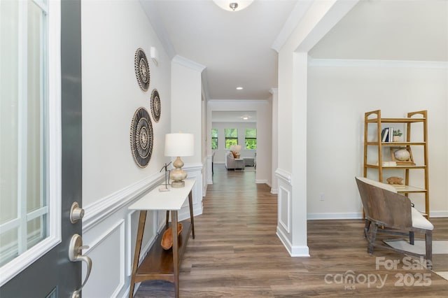 corridor featuring wood finished floors, crown molding, baseboards, and recessed lighting