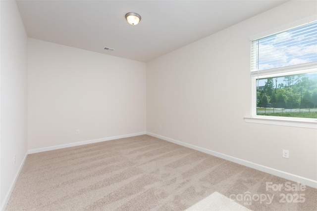 spare room with carpet flooring and baseboards
