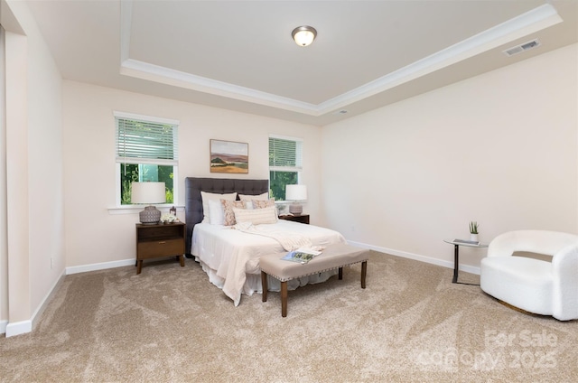 bedroom with a raised ceiling, carpet, multiple windows, and crown molding