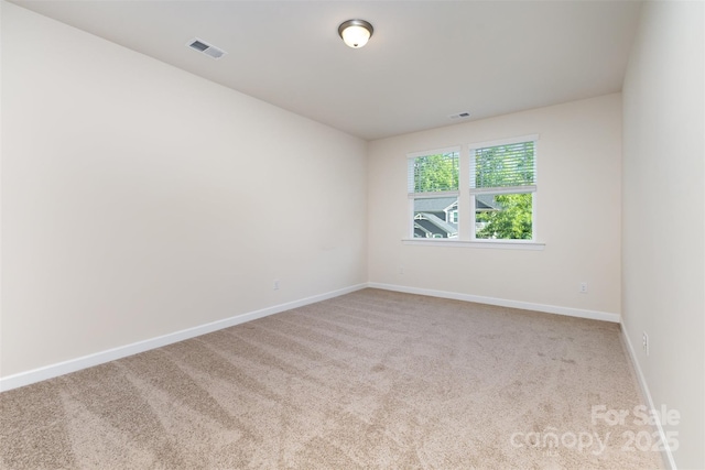 empty room with carpet and baseboards