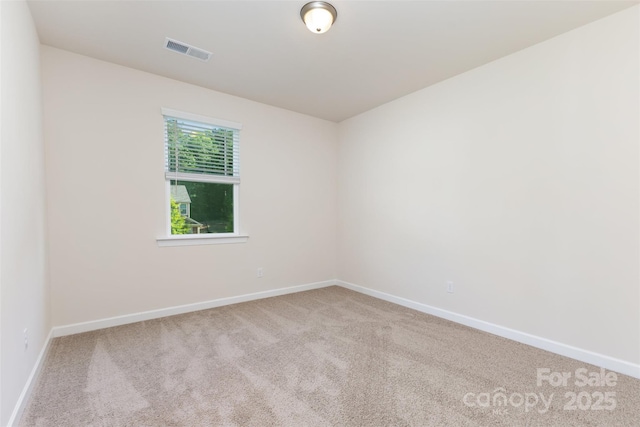 unfurnished room with carpet floors and baseboards