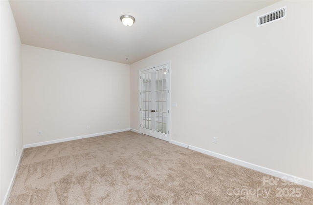 carpeted spare room featuring baseboards