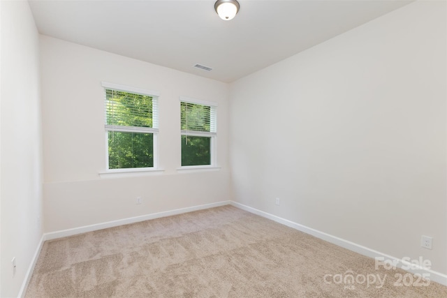unfurnished room with carpet and baseboards