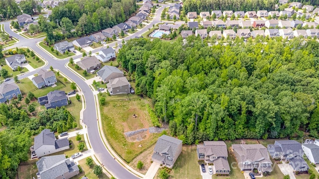 aerial view of property and surrounding area with nearby suburban area