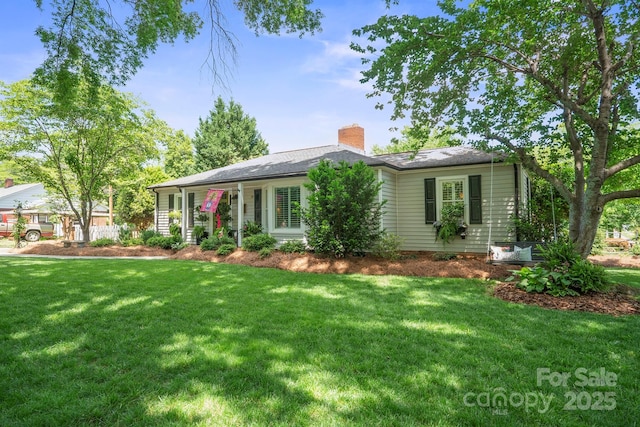 single story home featuring a front lawn and a chimney