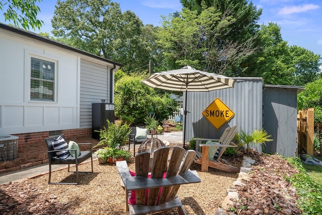 view of yard with cooling unit and an outbuilding