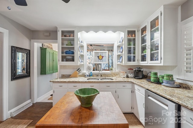 kitchen featuring white cabinets, stainless steel dishwasher, a ceiling fan, and a sink