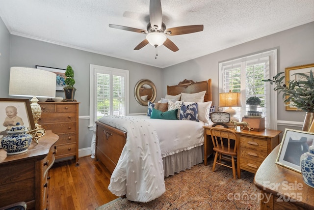 bedroom with multiple windows, ornamental molding, and a textured ceiling