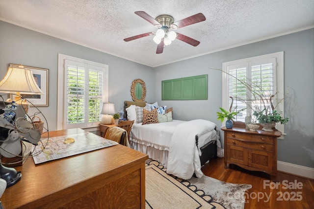 bedroom featuring a textured ceiling, wood finished floors, and ornamental molding