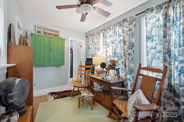 home office with baseboards and a ceiling fan