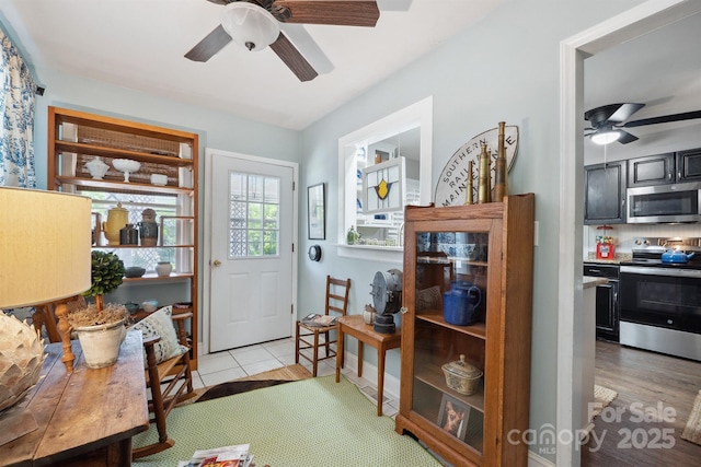 interior space with ceiling fan