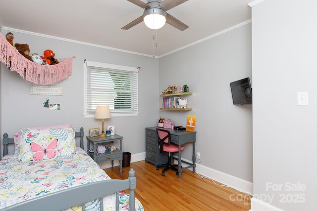 bedroom featuring crown molding, baseboards, and wood finished floors