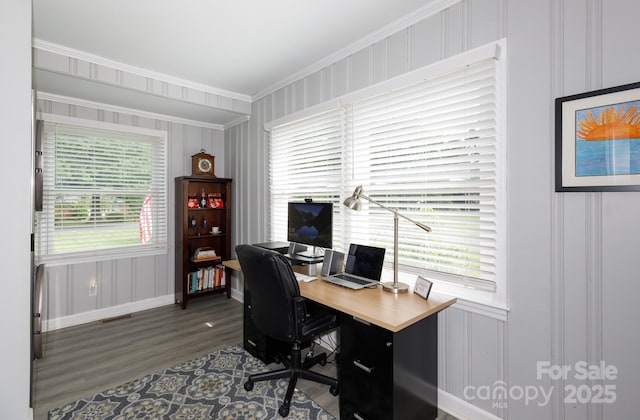 office featuring visible vents, wood finished floors, baseboards, ornamental molding, and a decorative wall
