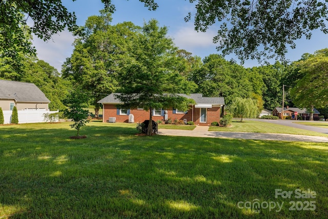 ranch-style house with brick siding and a front lawn
