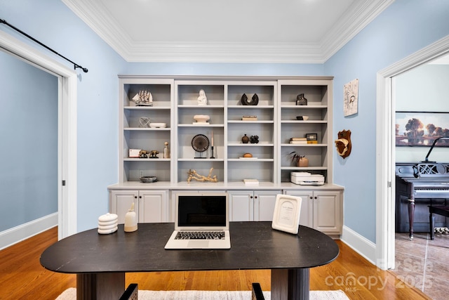 office with crown molding, baseboards, and light wood finished floors