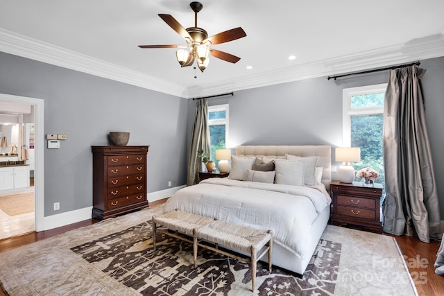 bedroom with ceiling fan, ornamental molding, wood finished floors, and ensuite bathroom
