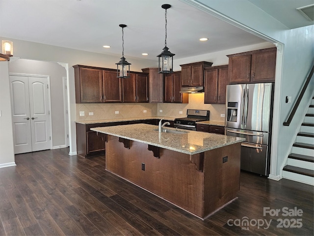 1071 Bassett Way, Fort Mill, SC 29707 - kitchen featuring appliances with stainless steel finishes, under cabinet range hood, a sink, dark brown cabinetry, and recessed lighting