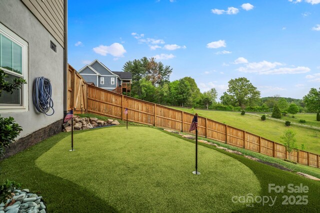view of yard with a fenced backyard