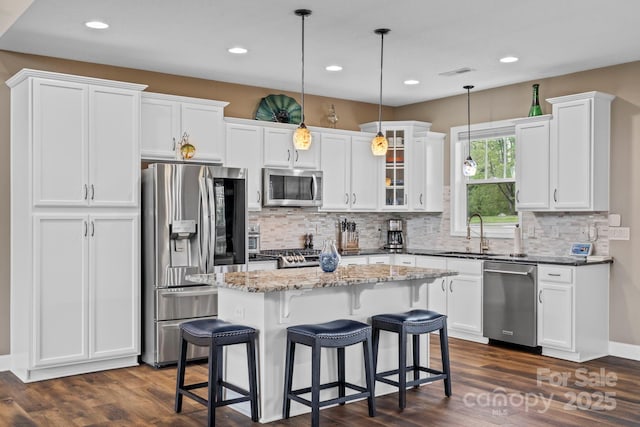 kitchen featuring appliances with stainless steel finishes, white cabinets, and dark wood-type flooring