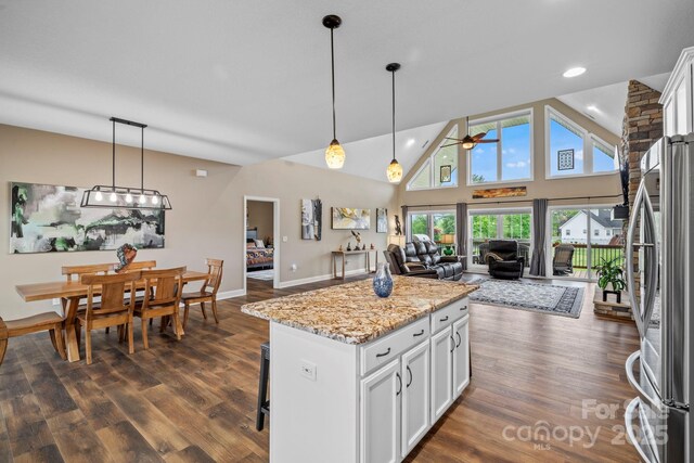 kitchen featuring freestanding refrigerator, pendant lighting, ceiling fan, dark wood-style floors, and white cabinetry