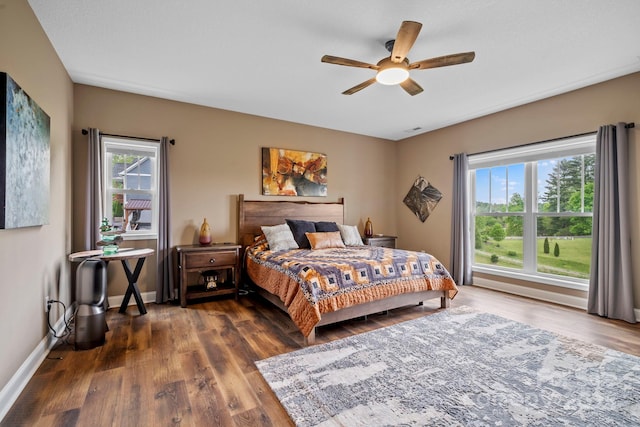 bedroom with baseboards, dark wood-style floors, and ceiling fan