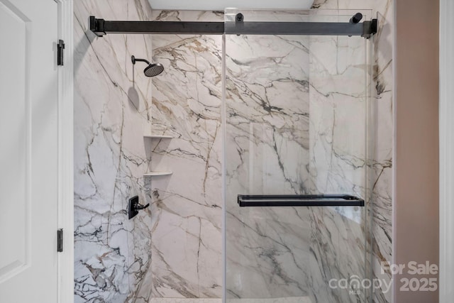full bath with a marble finish shower
